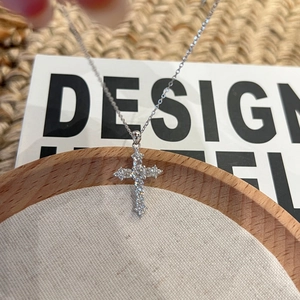 Elegant S925 sterling silver cross necklace with pavé moissanite stones on a dainty chain