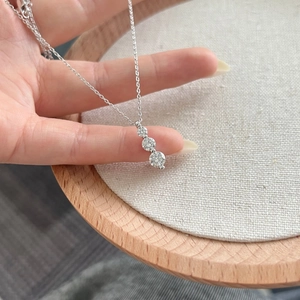 Elegant S925 sterling silver necklace featuring triple Moissanite stones in a row