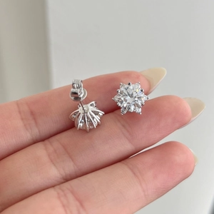 Close-up of S925 sterling silver snowflake earrings with sparkling moissanite stones