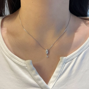 Close-up of S925 silver necklace with marquise-cut floating pendant on woman neck