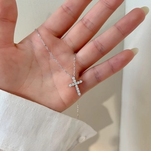 Close-up of a S925 sterling silver cross pendant necklace with sparkling pavé stones