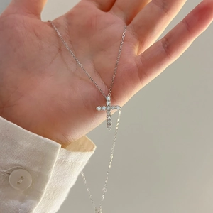 Sparkling S925 sterling silver cross pendant necklace worn on hand for women