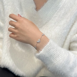 Detail of S925 sterling silver butterfly bracelet with shimmering pavé moissanite stones