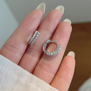 Detail showing S925 sterling silver hoop earrings with shimmering paved micro-diamonds