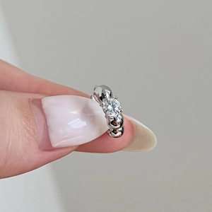 S925 sterling silver bubble ring with a round moissanite center stone held by hand