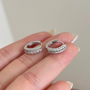 Detail view of small S925 sterling silver hoop earrings with double row paved zircons
