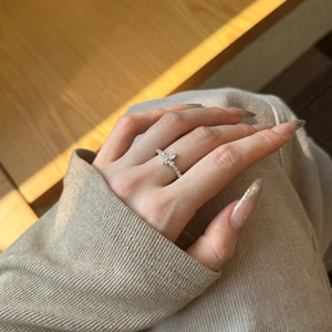 Close-up of S925 silver butterfly ring with marquise zircon stones on hand