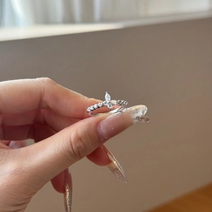 Detail of S925 silver ring featuring butterfly zircon inlay and floral design sparkles