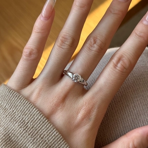 Detail of S925 sterling silver ring featuring star engravings and a round solitaire diamond