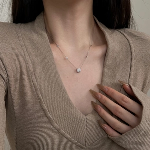 Elegant S925 sterling silver square pendant necklace worn on a beige knit sweater