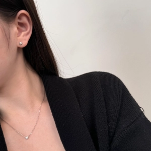 Model wearing minimalist S925 silver necklace and matching single diamond stud earrings