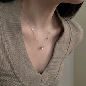 Close-up of S925 sterling silver necklace with square pendant and small accent stones