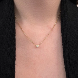 Detail of elegant S925 silver bezel set solitaire moissanite necklace on a model