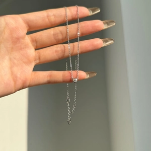 Close-up of S925 sterling silver necklace with round solitaire stone and lobster clasp