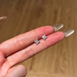 Detailed macro view of S925 sterling silver four-leaf clover earrings with micro-pave zircons