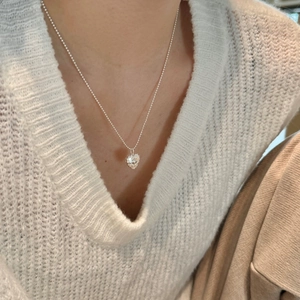 Detail of S925 sterling silver heart necklace with unique texture on a ball chain