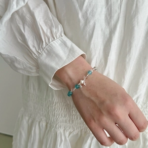 Close-up of S925 silver ocean bracelet with blue crystal beads and starfish charm