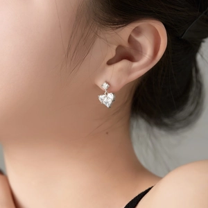 Elegant S925 sterling silver heart earrings with square cubic zirconia on a model