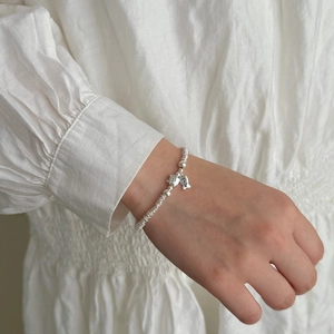 Close-up of S925 sterling silver beaded bracelet with cat and Smile fish charms