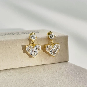 Detailed macro shot of S925 sterling silver stamp on golden heart stud earrings