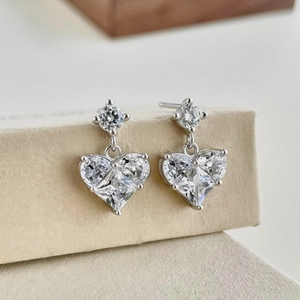 Macro shot of S925 sterling silver heart earrings with sparkling zircon gemstones