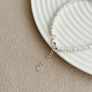 Elegant S925 sterling silver coil bracelet with heart charm and lobster clasp closure