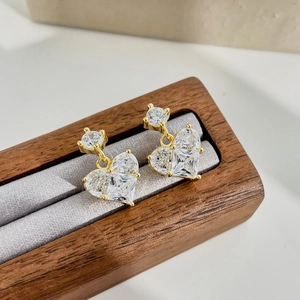 Detail of S925 silver gold-plated heart earrings with sparkling cubic zirconia stones