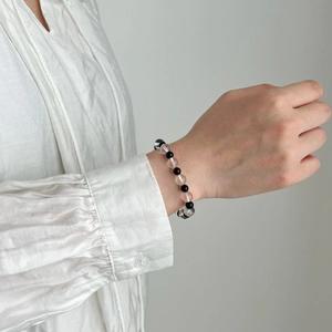 Minimalist black agate and white crystal beaded bracelet for women on model wrist