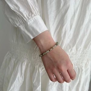 Detail of S925 silver bracelet featuring green rutilated quartz and freshwater pearls