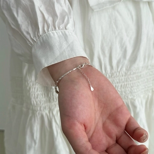 Close-up of S925 sterling silver bracelet showing small square beads and S925 hallmark