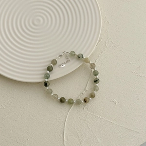 Detail of silver bracelet with green rutilated quartz and natural freshwater pearls