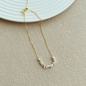 Detail view of two-tone S925 sterling silver chain with irregular beads and spring clasp