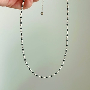 Close-up of S925 sterling silver and black bead necklace with adjustable extension chain