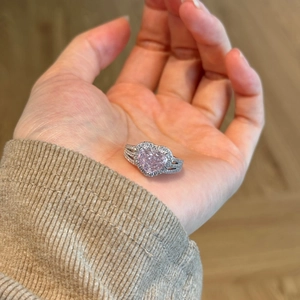Detailed shot of S925 silver heart ring with pink gemstone and double-row pavé band