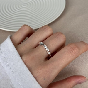 Minimalist S925 sterling silver irregular wave ring with modern lava texture on model hand