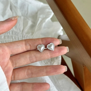 Elegant S925 sterling silver heart stud earrings with matte center and pavé texture