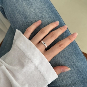 Close-up of S925 sterling silver irregular wave ring on finger for a minimalist look