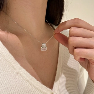 Close-up of S925 silver necklace with pink square gemstone and sparkling zircon detail