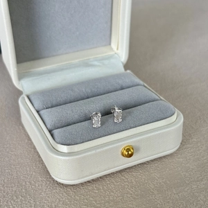 Macro view of S925 silver stud earrings with rectangle cut stones in a luxury gift box