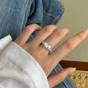 S925 sterling silver ring with blue zircons and irregular texture worn on a finger