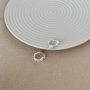 Detailed view of S925 sterling silver hoop earrings with textured rock-like surface