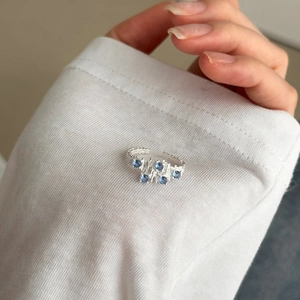 Close-up of S925 sterling silver ring featuring blue zircon stones and textured finish