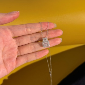 Detail of S925 silver necklace with pink square pendant and micro-paved diamonds