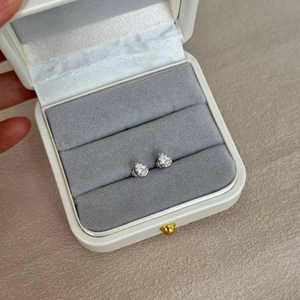 Close-up of S925 sterling silver emerald cut stud earrings in a luxury jewelry box