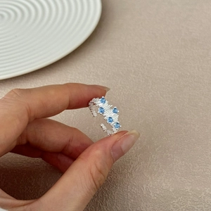 S925 sterling silver open ring with blue zircons and irregular texture, handheld view