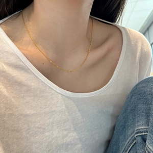 Close-up of minimalist gold S925 sterling silver chain necklace on a model