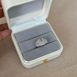 Macro detail of silver ring featuring a rectangular pink gemstone in a jewelry box