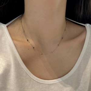 Detail of S925 sterling silver collar necklace with colorful zircons on a model