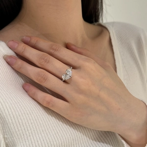 Detailed view of Toi et Moi silver ring with dual pear-cut stones and pavé diamonds