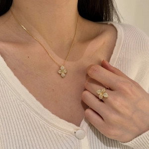 Detailed close-up of a gold butterfly jewelry set featuring sparkling pavé crystals